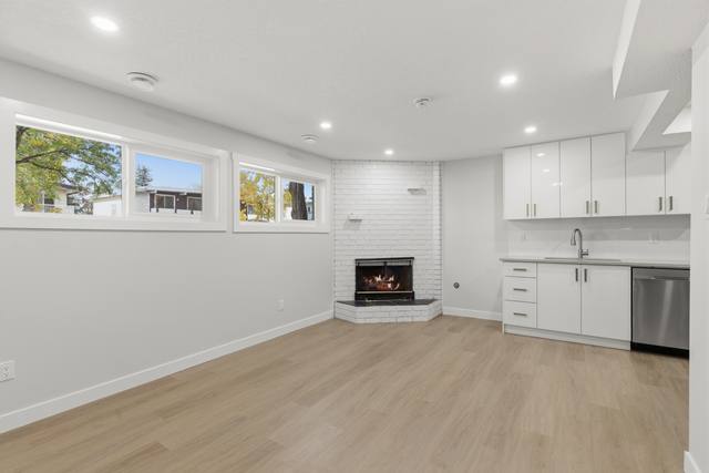 Lower suite: rec room with fireplace and kitchen