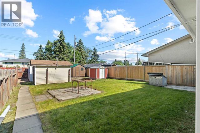 Fenced backyard and garage